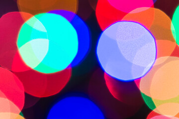 Beautiful defocused multicolored lights on black background