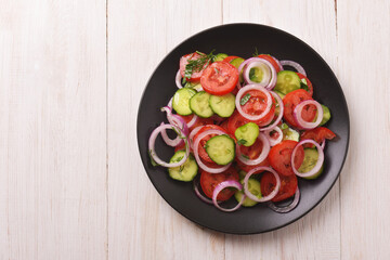 Top view of fresh tomatoes cucumber vegetable salad