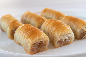Turkish sweetness - baklava on a white plate close-up.