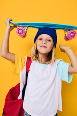 stylish girl with a skateboard on his head isolated background © SHOTPRIME STUDIO