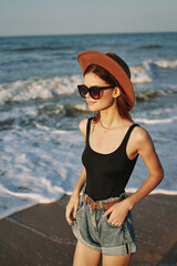 Fototapeta na wymiar woman walking on the beach hat travel vacation sun