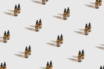 Pattern unbranded bottles in mockup style with shadow top view. Tube of eye oil on a white background. Beauty background with facial cosmetic products. Spa, beauty concept.