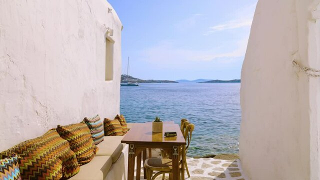 Reserved table in an outdoor romantic restaurant near the Mediterranean Sea in Mykonos, Greece
