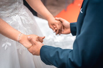 A couple shaking hands at the wedding ceremony, essential moments in a couple's relationship, photos at the wedding celebration