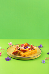 Belgian waffles with cream figs flowers and berries