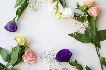 Flowers and leaves scattered on a table, overhead view wallpaper. Lay flat, top view. 