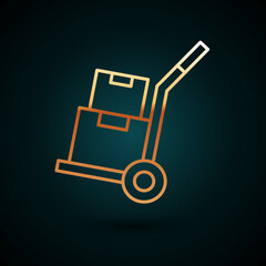 Gold line Hand truck and boxes icon isolated on dark blue background. Dolly symbol. Vector