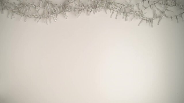 Merry Christmas. flat lay with Christmas lights on white background. This video was shot in PRORes 422 codec.