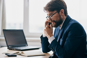 businessmen sitting at a desk in front of a laptop stress anger technologies