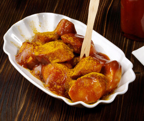 Curry Sausage with Sauce on wooden Background