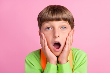 Portrait of attractive amazed boy newa reaction omg opened mouth isolated over bright pink color background