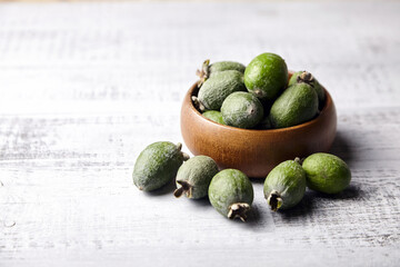 Feijoa fruits or pineapple guava in bowl on wooden table