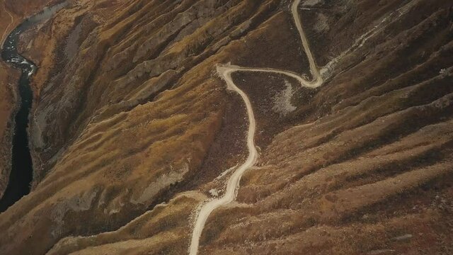 Katu Yaryk mountain pass in the valley of the Chulyshman River, Altai, Siberia, Russia. A dangerous empty serpentine highway, a huge stone gorge, a canyon, a mountain winding river. Freedom