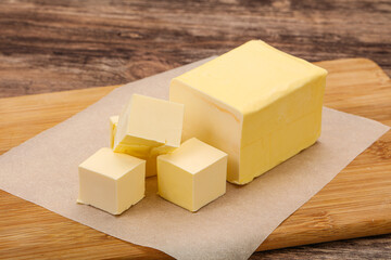 Dairy natural yellow butter piece - obrazy, fototapety, plakaty