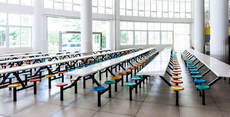Modern school cafeteria with empty seats and tables