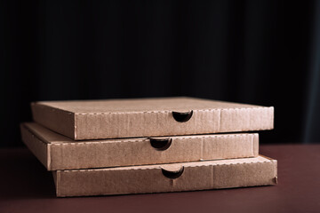 Three pizza boxes stacked on top of each other