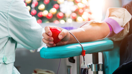 Blood donor at donation with bouncy ball holding in hand