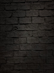 close up shot at the surface of black bumpy brick pattern wall with stamped of dog footprint. natural stone brick wall texture for loft, industrial concept design. high defination image.