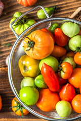 Colorful Ripe Tomatoes on Wooden Table