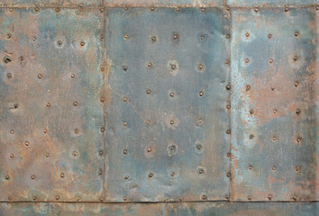 Very old rusted metal sheet with nails