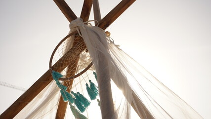 Dreamcatcher tied to a tent on the beach © JFNoah