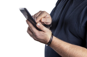 A man holds a phone in handcuffs on a white background, isolated. Concept: a slave to technology, the right to one call, communication with a lawyer.