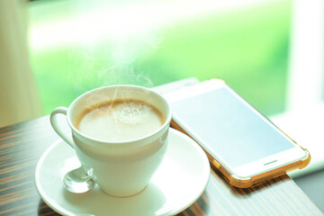 The time of morning hot coffee by the window with hot smoke and fresh aroma.