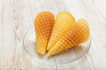 Wafer rolls and ice cream bags. Homemade cakes on a wooden table. Photo