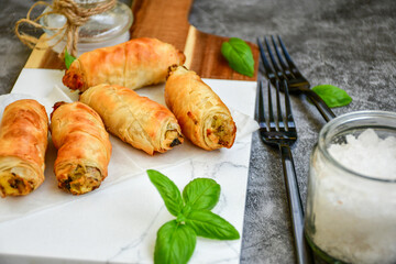  Greek style Mini filo pastry rolls with mushrooms.Home made bakery .Fresh baked  Mini cheese  ,meat and herbs puff pastries