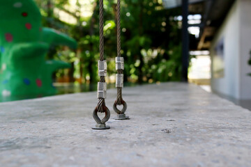 Close-up view of vertical sling embedded in cement floor for strong adhesion to the structure.