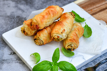  Greek style Mini filo pastry rolls with mushrooms.Home made bakery .Fresh baked  Mini cheese  ,meat and herbs puff pastries
