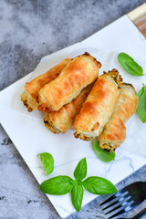  Greek style Mini filo pastry rolls with mushrooms.Home made bakery .Fresh baked  Mini cheese  ,meat and herbs puff pastries