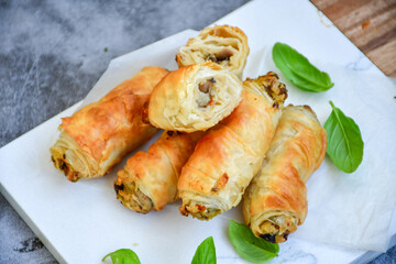  Greek style Mini filo pastry rolls with mushrooms.Home made bakery .Fresh baked  Mini cheese  ,meat and herbs puff pastries