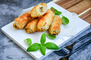  Greek style Mini filo pastry rolls with mushrooms.Home made bakery .Fresh baked  Mini cheese  ,meat and herbs puff pastries