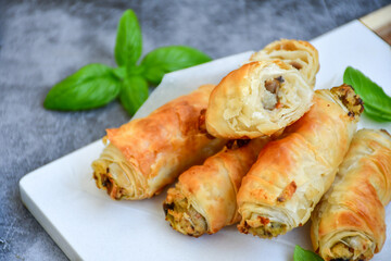  Greek style Mini filo pastry rolls with mushrooms.Home made bakery .Fresh baked  Mini cheese  ,meat and herbs puff pastries