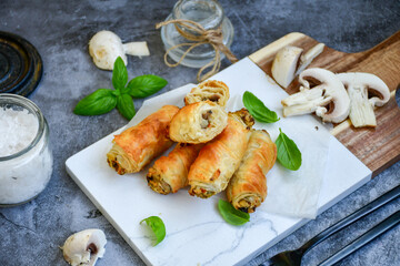  Greek style Mini filo pastry rolls with mushrooms.Home made bakery .Fresh baked  Mini cheese  ,meat and herbs puff pastries