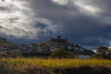 Fototapeta na wymiar View of the small town of Trasmoz and its unmistakable castle from the 12th century, against a dark, sunset and cloud-covered landscape, Aragon