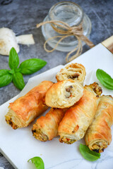  Greek style Mini filo pastry rolls with mushrooms.Home made bakery .Fresh baked  Mini cheese  ,meat and herbs puff pastries