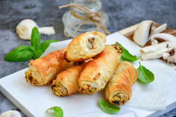  Greek style Mini filo pastry rolls with mushrooms.Home made bakery .Fresh baked  Mini cheese  ,meat and herbs puff pastries