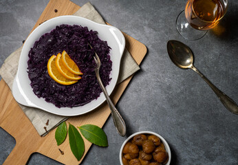 food red cabbage glaced chestnuts white plate wood board grey table