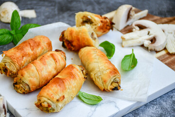  Greek style Mini filo pastry rolls with mushrooms.Home made bakery .Fresh baked  Mini cheese  ,meat and herbs puff pastries