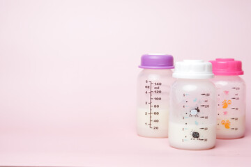 A picture of 3 storage of breast milk on copyspace pink background. Breast milk is definitely great nutrition, great protein and great calories and  low in calories for an adult. - obrazy, fototapety, plakaty