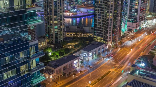 Aerial view on Dubai Marina skyscrapers and the most luxury yacht in harbor night timelapse, Dubai, United Arab Emirates