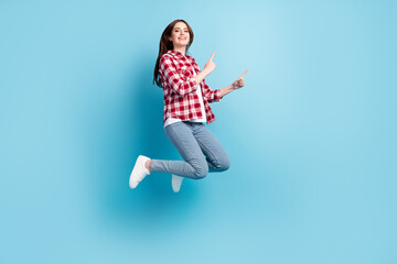 Full body profile photo of funny millennial brunette lady jump point wear red shirt jeans isolated on blue color background