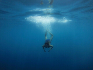 girl dives into the blue water