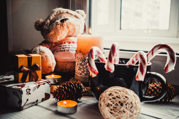 Soft toy and candles on wooden white background with christmas decorations