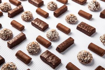 Assorted chocolate candies on wooden background. Chocolate sweets. Dessert background.