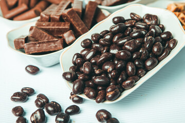 Assorted chocolate candies on wooden background. Chocolate sweets. Dessert background.