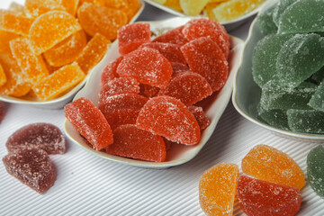 Dessert marmalade in the form of lemon and orange slices. The sweetness of jelly candy.