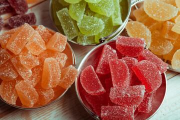 Dessert marmalade in the form of lemon and orange slices. The sweetness of jelly candy.